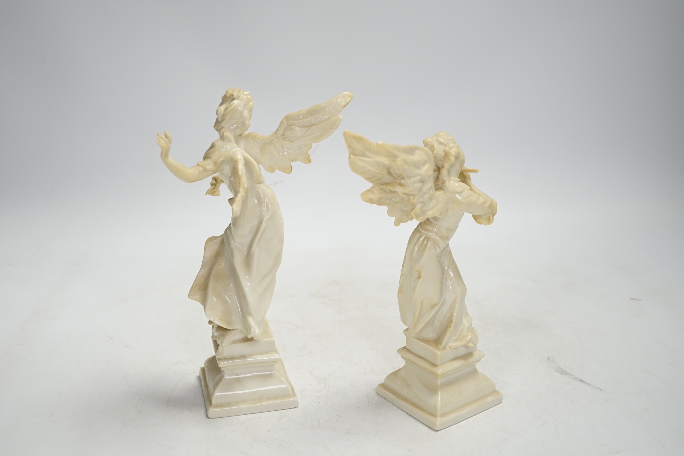 A pair of Nymphenburg white glazed figures of angels, tallest 18.5cm high. Condition - grubby, otherwise good